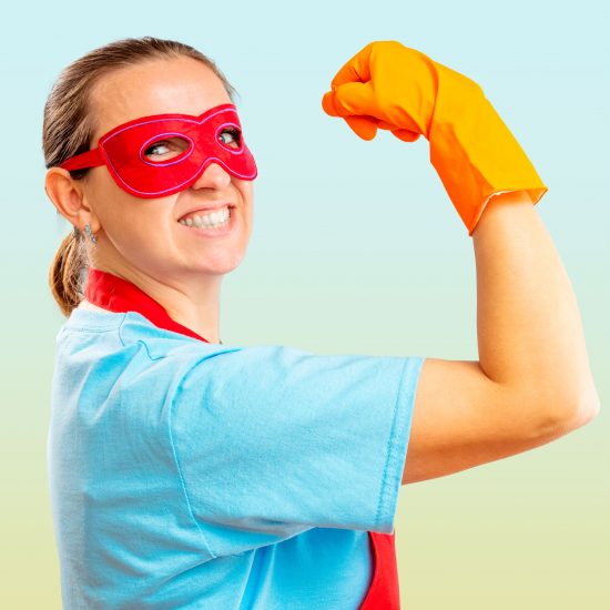 Confidence superhero house cleaner showing her powerful muscle
